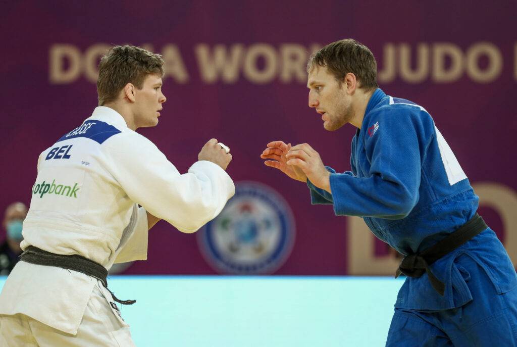 Robin Pacek i blå judodräkt och Matthias Casse vit judodräkt står mitt emot varandra med händerna uppe, beredd att ta tag i varandra i början av en match.