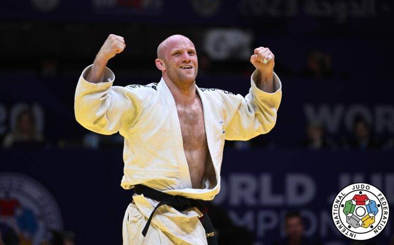 Marcus Nyman i vit judodräkt höjer knutna nävar i segergest.